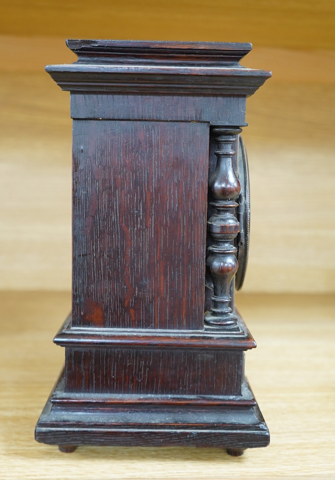 A late Victorian oak eight day mantel clock, striking on a coiled gong, height 26.5cm. Condition - fair, wear and oxidisation to dial.